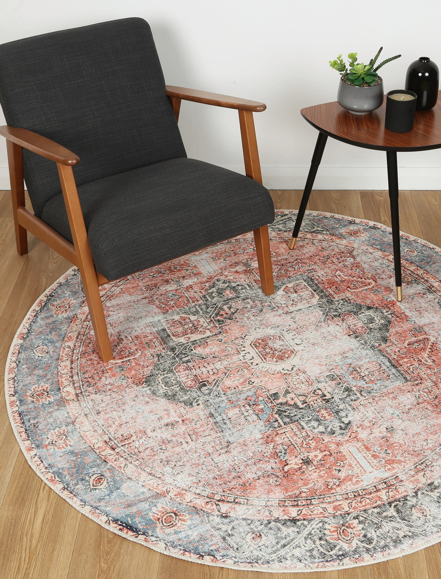 Vintage Crown Cezanne terracotta round rug paired with a modern chair and table in a stylish living space.