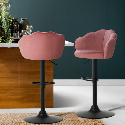 Stylish velvet pink bar stools with backrest and gas lift feature in a modern kitchen setting.