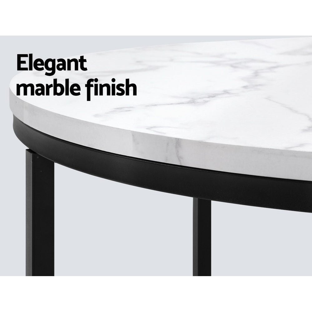 Elegant marble finish on round coffee table with black metal base, ideal for modern home décor.