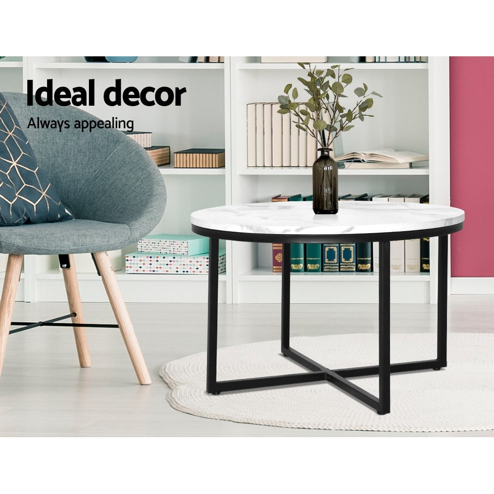 Stylish round coffee table with marble finish and black metal base, perfect for modern home decor.