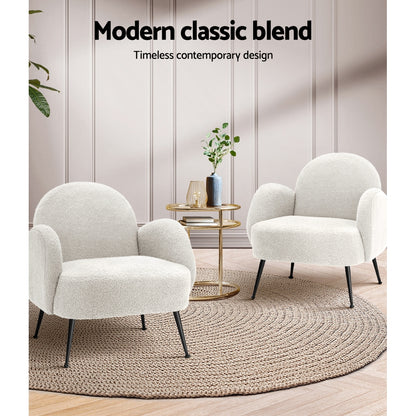 Stylish white bouclé accent armchairs in a modern living room setting, featuring a contemporary design and cozy texture.