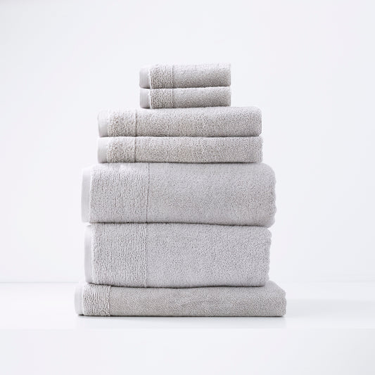 Vapour color Aireys 7 piece 650 GSM zero twist luxury bath towels by Renee Taylor stacked in bathroom display.