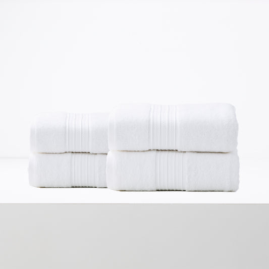 Bright white bath sheet set of four made from soft low-twist cotton, perfect luxury towels for quick drying and all-season use.