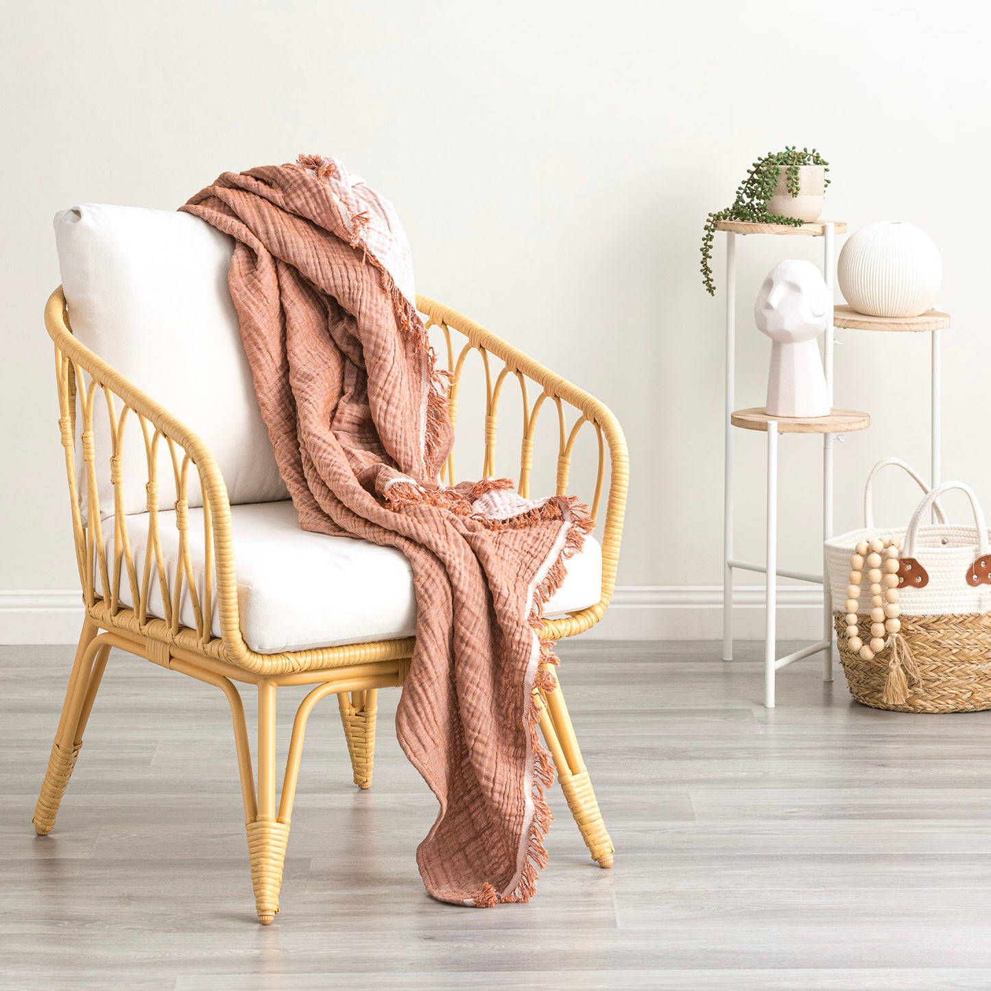 Cozy vintage washed cotton throw blanket draped over a stylish chair in a light-filled room. Perfect for year-round comfort.