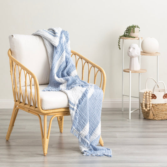 Ray Striped vintage washed cotton throw blanket draped over a chair, adding style and comfort to your space.