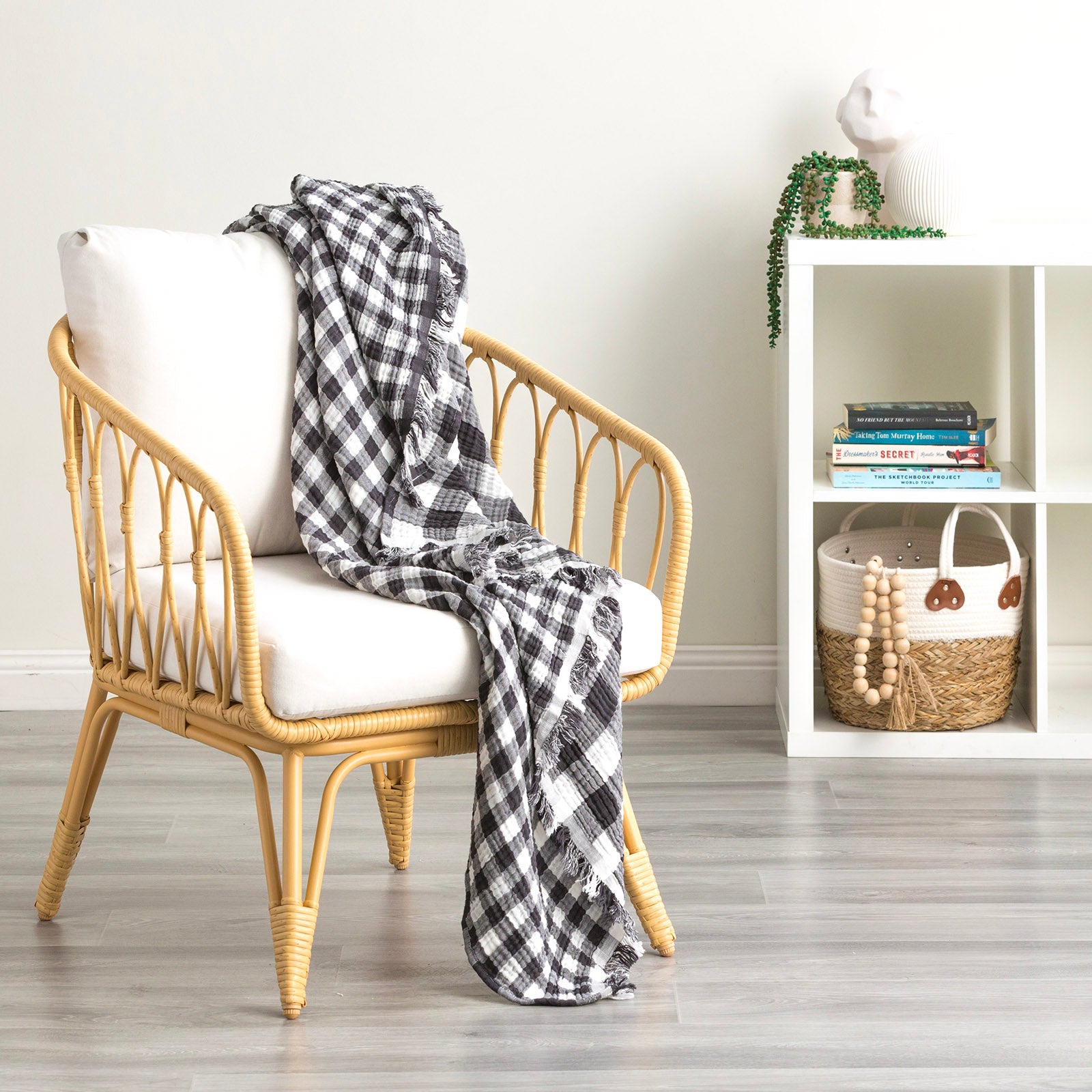 Atlantic reversible vintage washed cotton throw blanket draped over a chair, featuring a black and white buffalo check pattern.