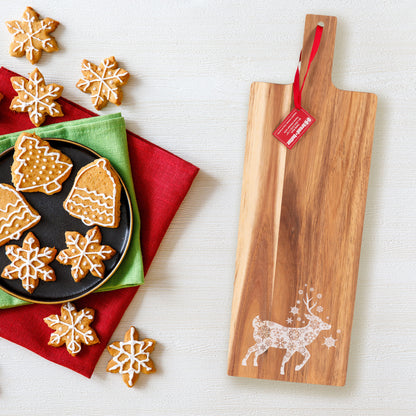 Elegant acacia wood paddle board with holiday cookies, perfect for festive table decorations and serving platters.