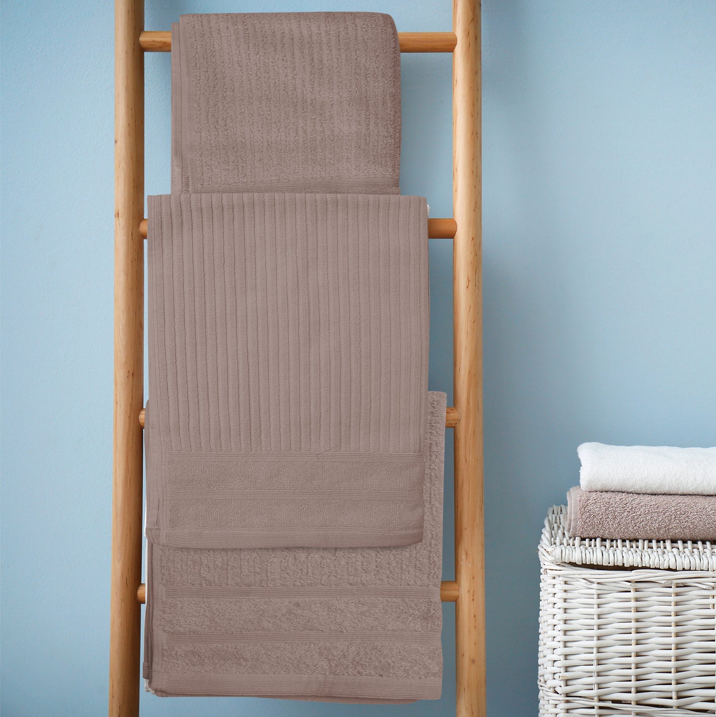 Luxury rose Egyptian cotton bath towels set of 8, 600GSM, displayed on a wooden rack in a bathroom.