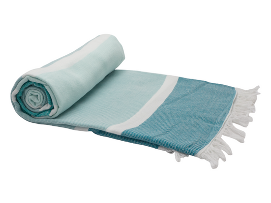 Rolled Portsea Turkish cotton beach towel in ocean colors, perfect for beach days and quick drying.