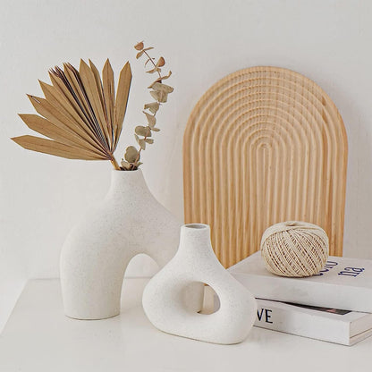 Modern white ceramic vase set with dried plants, enhancing stylish home decor for any room.