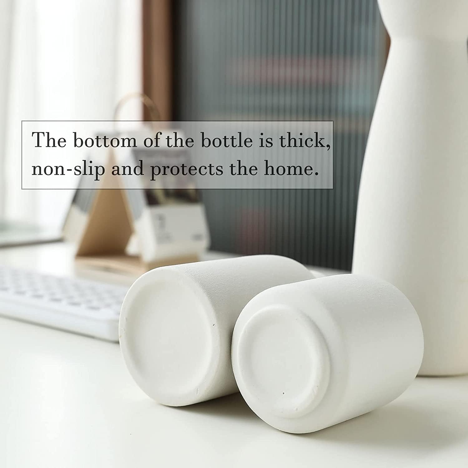 Modern white ceramic vases with thick non-slip bases, perfect for home decor and flower displays.