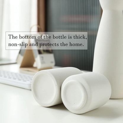 Modern white ceramic vases with thick non-slip bases, perfect for home decor and flower displays.