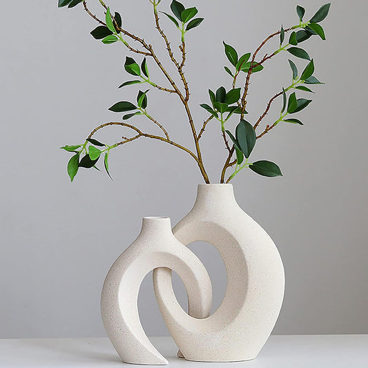 Creative white ceramic vase set for home decor with elegant design and greenery. Perfect for adding style to any space.