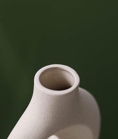 Close-up of a ceramic vase showcasing a minimalist design and smooth texture, perfect for elegant home decor.