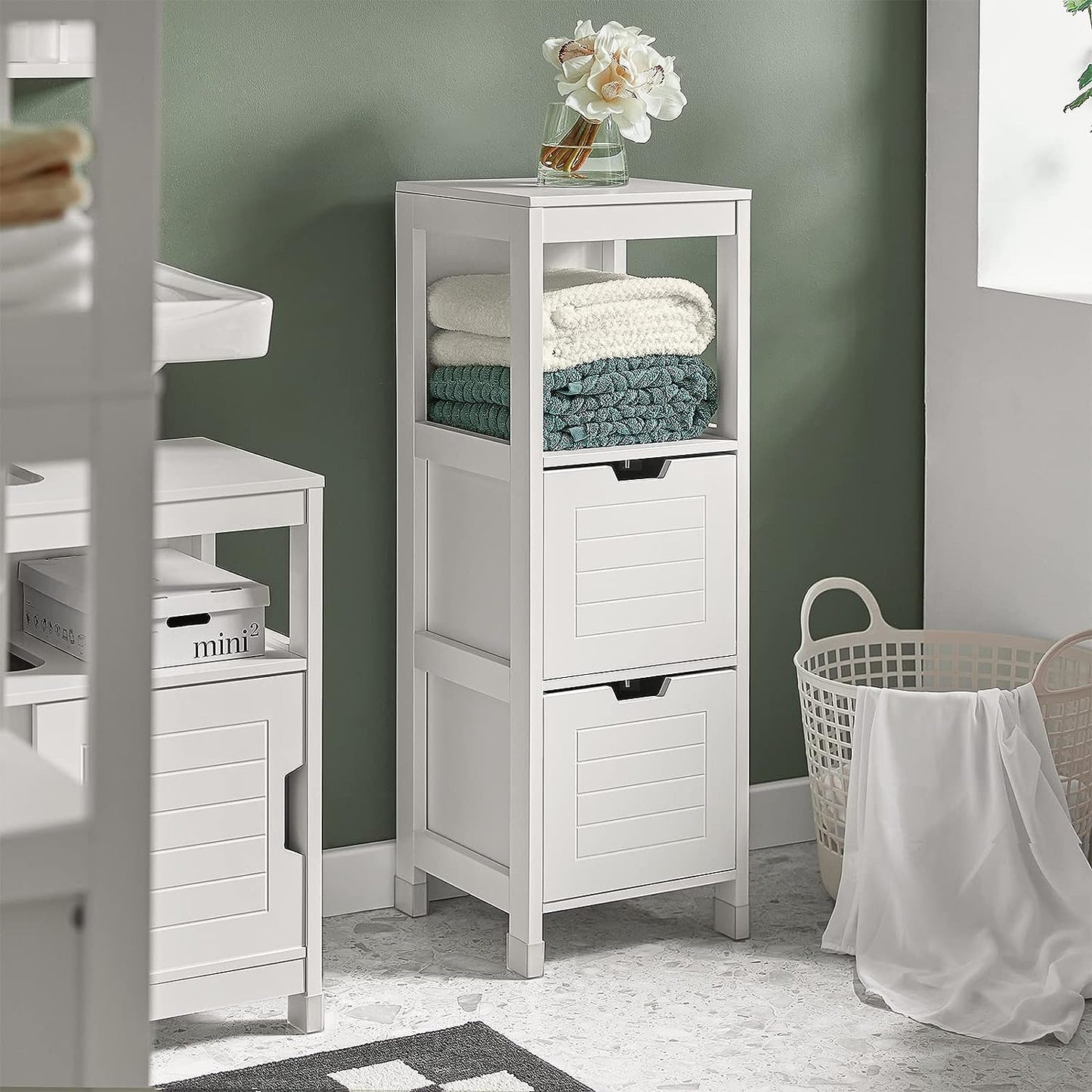 Stylish freestanding cabinet with two drawers and shelf for organized storage in a modern bathroom.