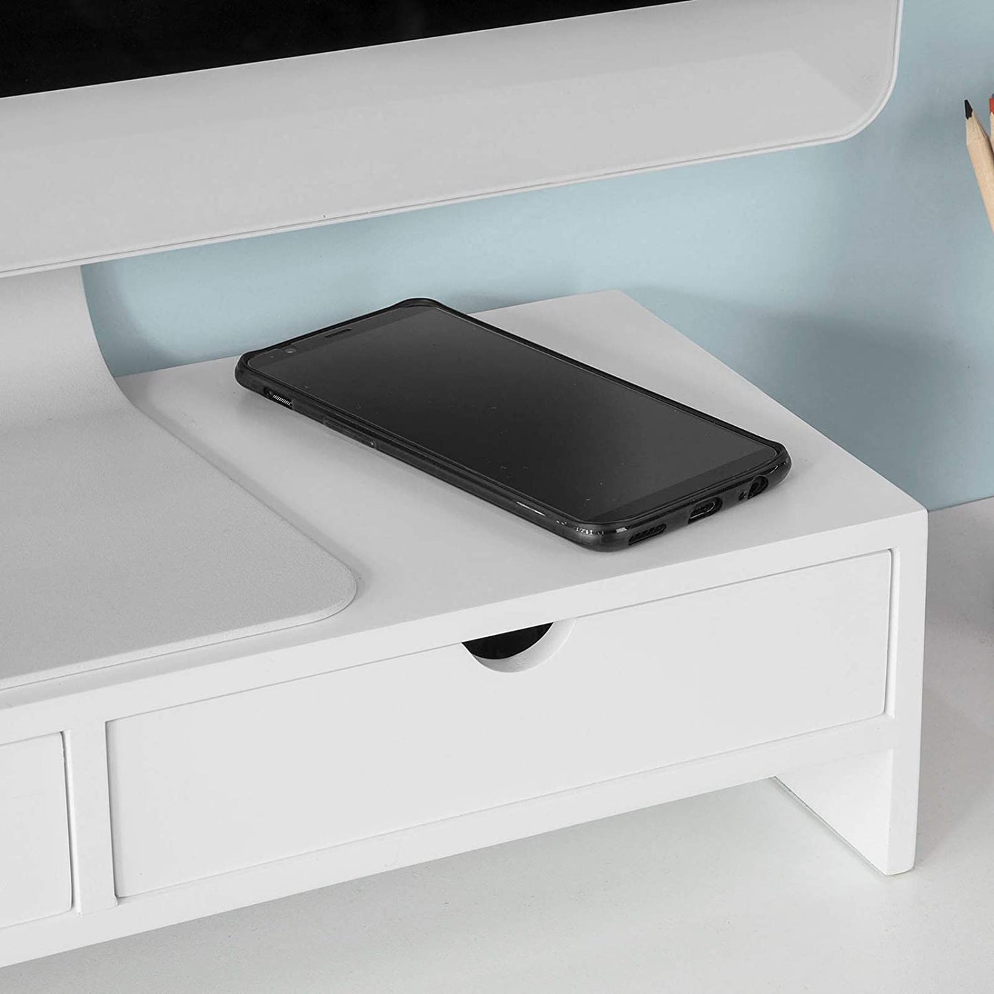 White monitor stand desk organizer with a smartphone placed on top, showcasing convenient design and storage options.