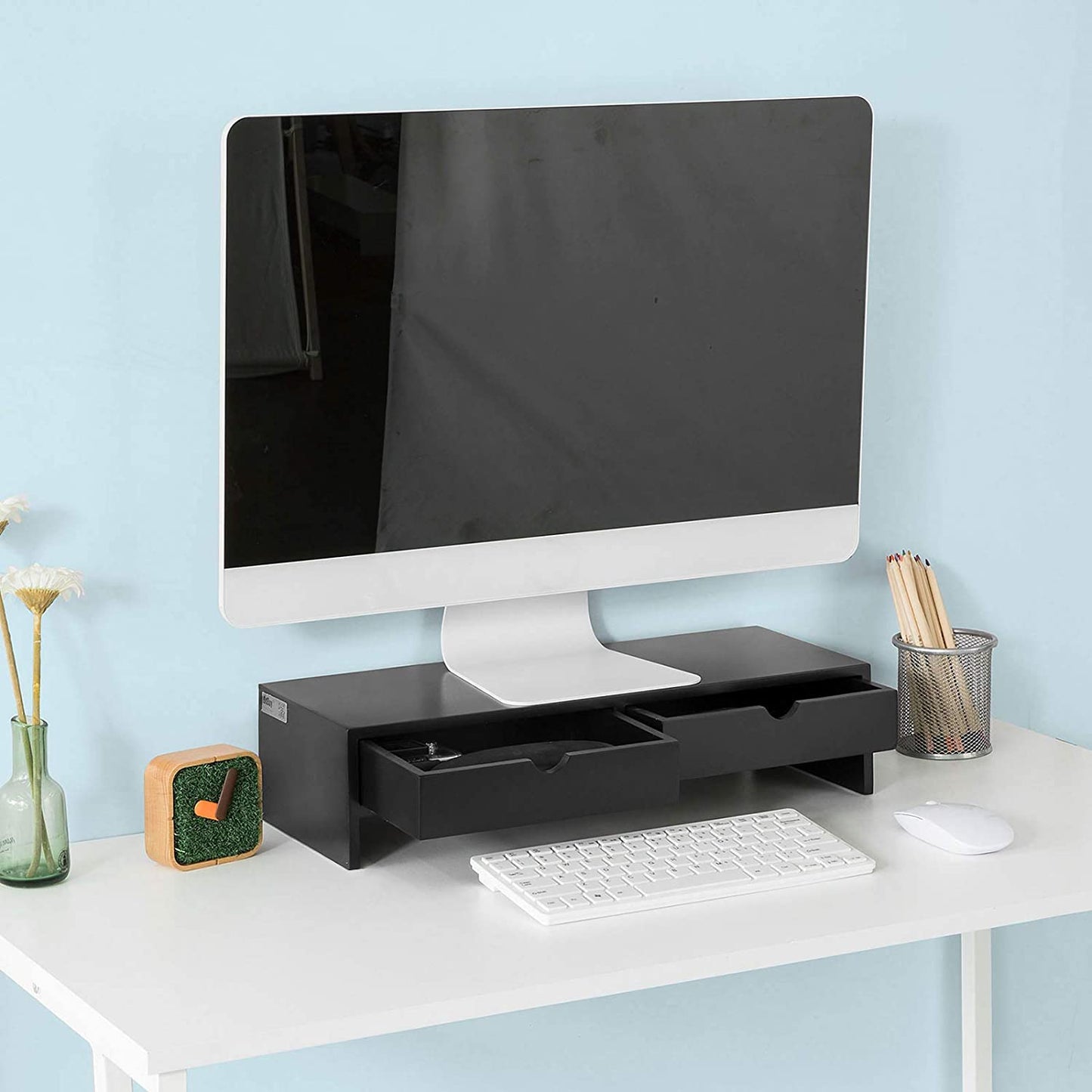 Black monitor stand desk organizer with 2 drawers, enhancing workspace efficiency and comfort for monitor placement.