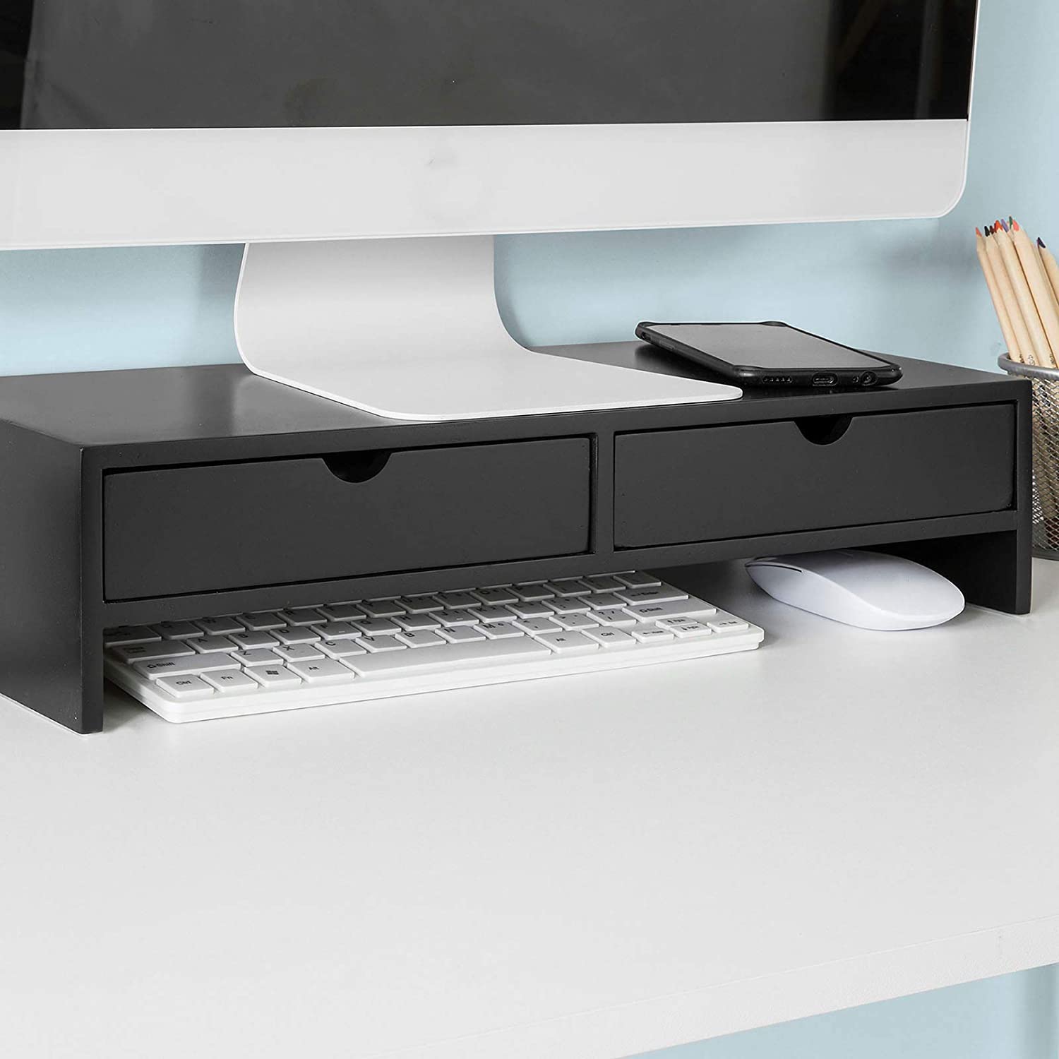 Black monitor stand desk organizer with 2 drawers, keyboard, and mouse for improved workspace efficiency.