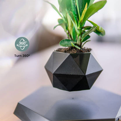 Black GOMINIMO floating plant pot spinning above base, showcasing levitation. Ideal for small plants. Unique, eye-catching design.