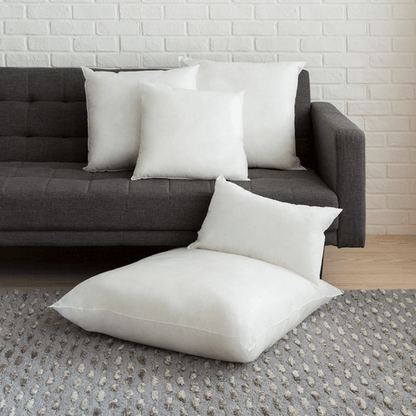 Soft polyester cushion inserts arranged on a couch, ideal for home decor and comfort. Perfect for sofa and couch cushions.