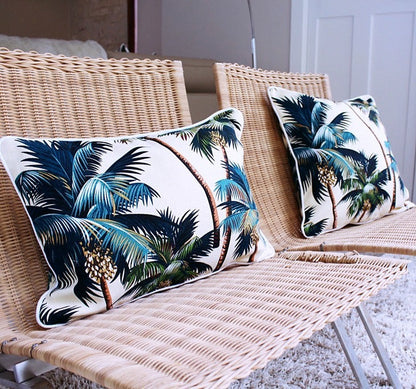 Decorative cushion covers with palm trees design on woven chairs, perfect for tropical-inspired home décor.