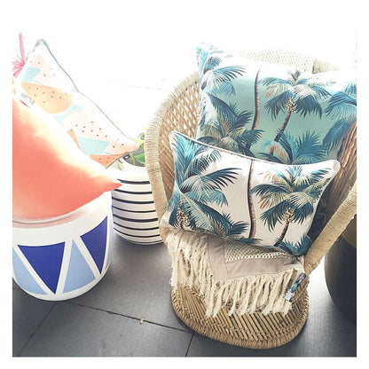 Decorative palm tree cushion covers on a wicker chair, enhancing a tropical home decor vibe. Perfect for indoor or outdoor use.