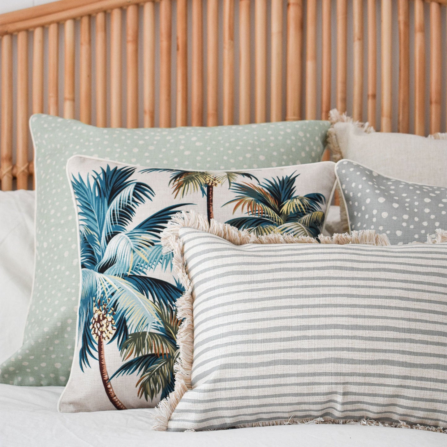 Decorative cushion covers featuring palm trees and fringing, perfect for tropical-inspired home décor.