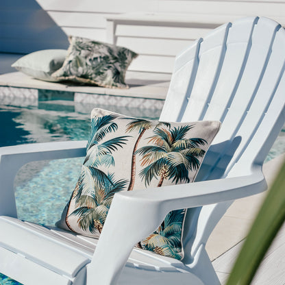 Cushion cover with palm trees on a white chair by the pool, adding a tropical vibe to outdoor decor.