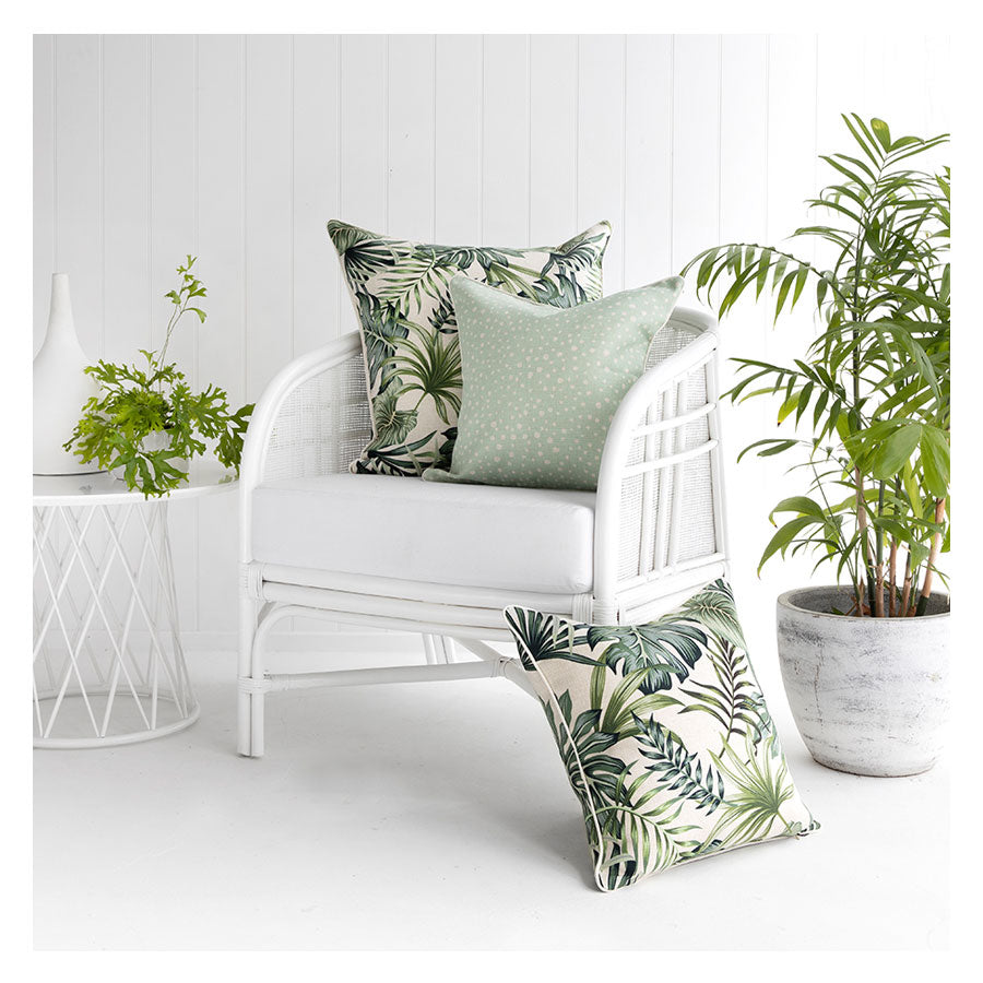 Tropical cushion covers on a white chair, enhancing indoor decor with a relaxed, resort-style vibe.