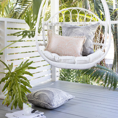 Tropical-inspired hanging chair featuring stylish cushion covers in Seminyak Smoke tones, perfect for home decor.