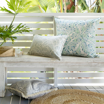 Stylish cushion covers on a wooden bench, enhancing a tropical home decor with soft textures and natural colors.