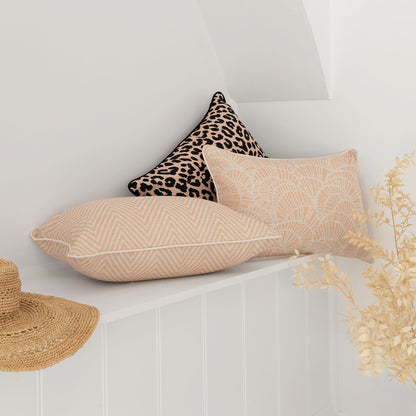 Stylish cushion covers in blush zig zag and leopard print on a shelf, perfect for enhancing your home décor.