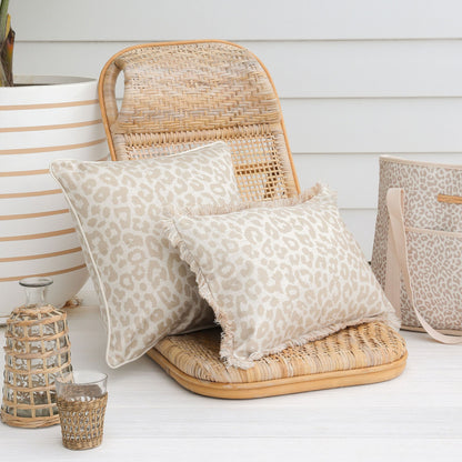 Two leopard print cushion covers on a rattan chair, perfect for adding a tropical touch to your home decor.