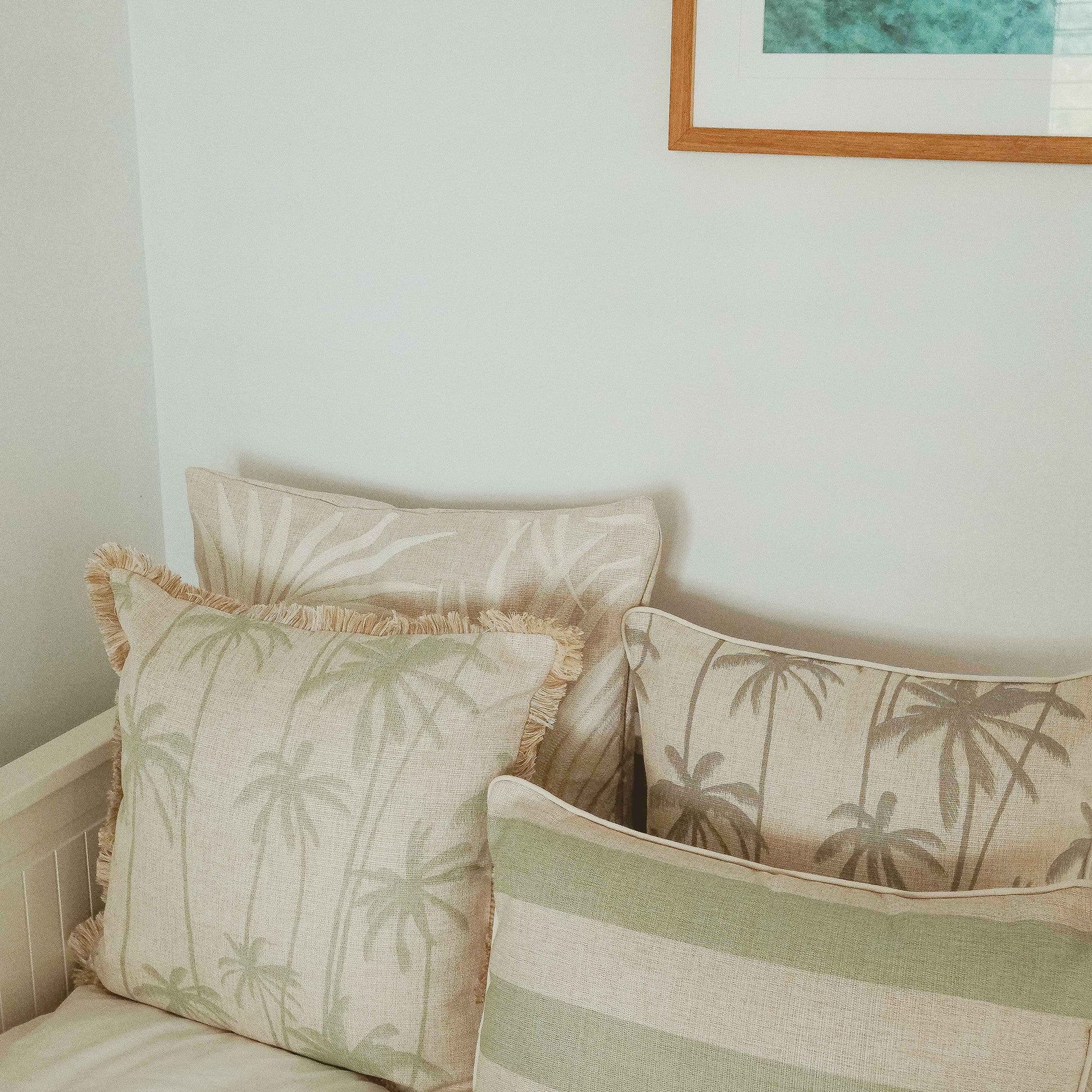 Decorative cushion covers with palm prints and fringe, adding a tropical vibe to any couch or sofa setup.