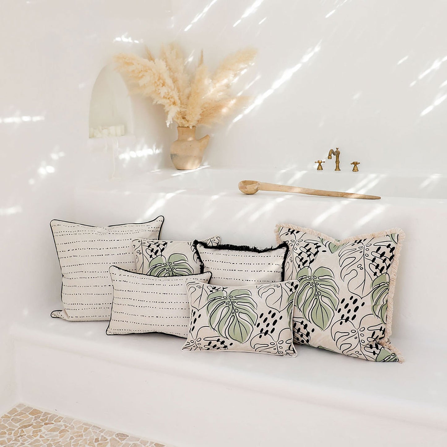 Decorative cushion covers in tropical designs displayed on a white sofa, perfect for indoor or outdoor decor.