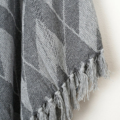 Soft cotton throw blanket in grey with herringbone plaid pattern and fringe detail, ideal for adding comfort to your home décor.