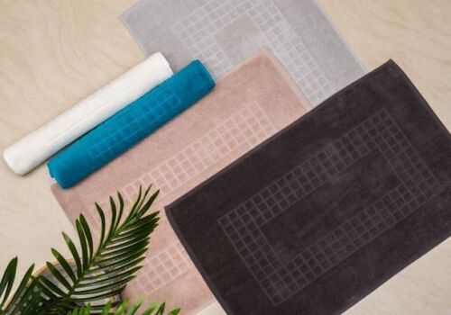 Collection of soft microfiber bath mats in various colors and designs, perfect for elevating bathroom aesthetics.