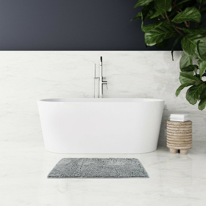 Microfiber bath mat in a modern bathroom with a freestanding tub and greenery, showcasing soft pile and non-slip design.