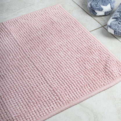 Soft pink microfiber bath mat with non-slip design, ideal for a warm and cozy bathroom experience.