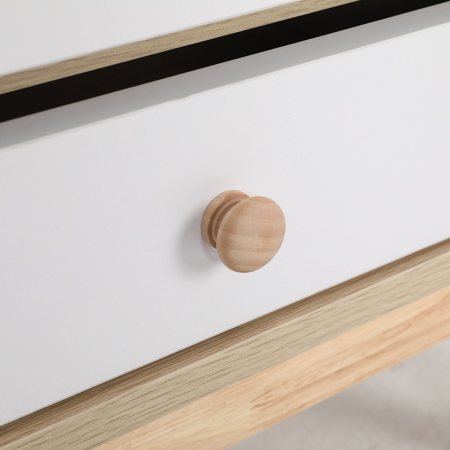 Close-up of oak drawer knob on La Bella bedside table with white finish.