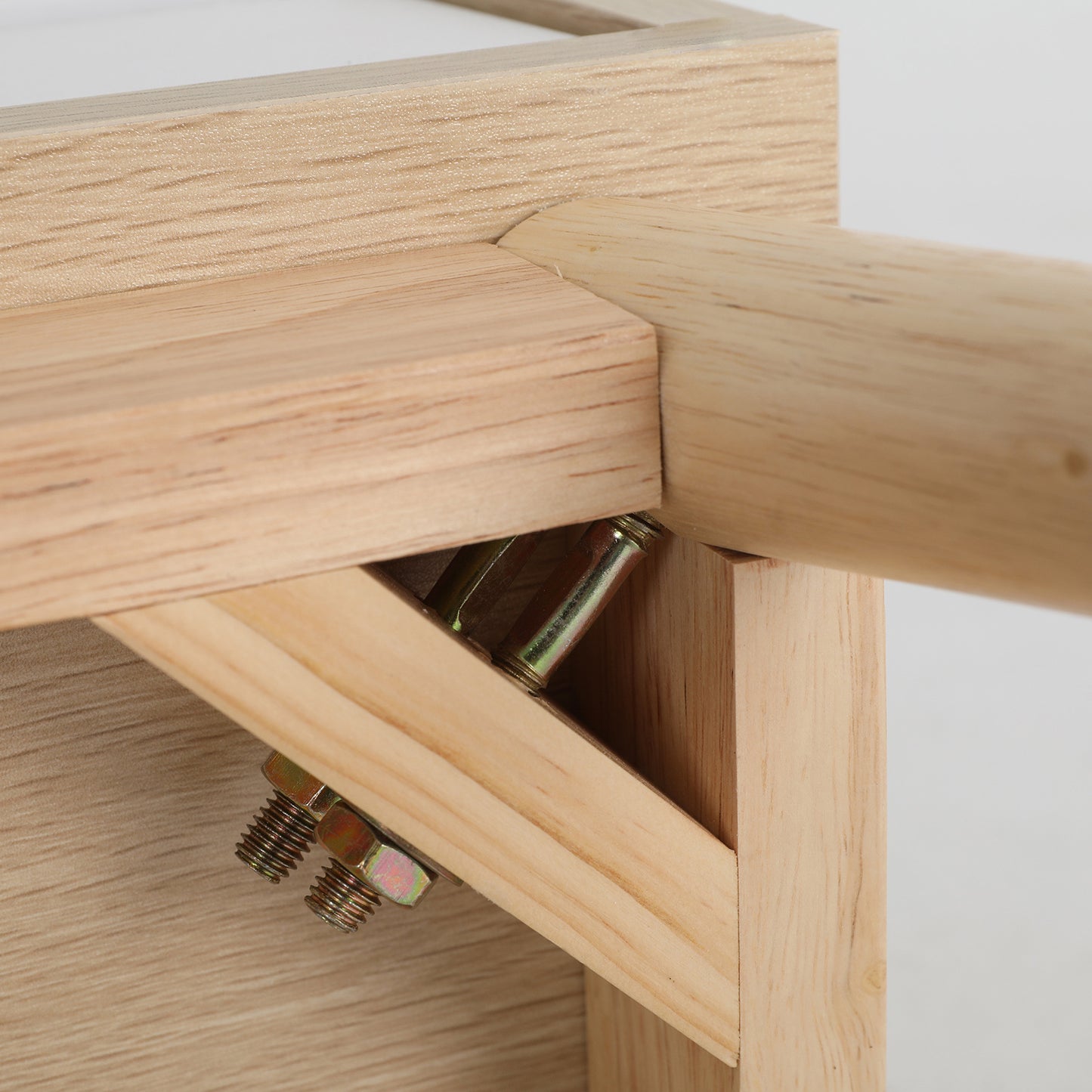 Close-up of oak wood assembly details on the La Bella bedside table, showing sturdy construction and quality craftsmanship.