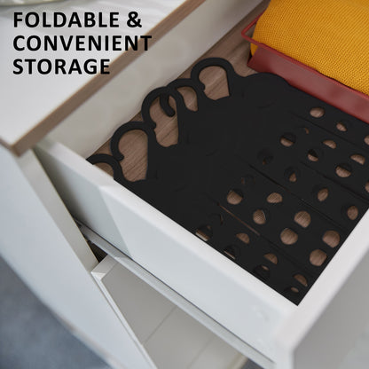 Foldable black coathangers neatly stored in a drawer for convenient clothes storage and organization.