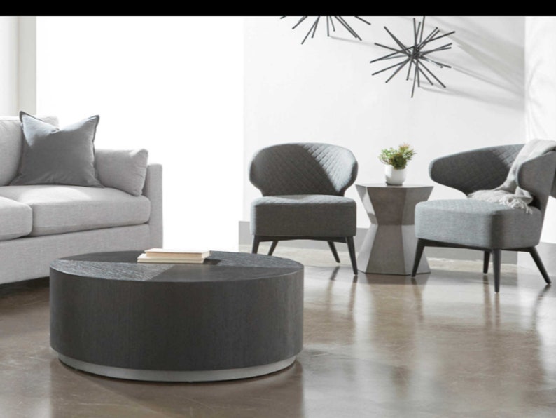 Tablua round coffee table styled in a modern living room with decorative items