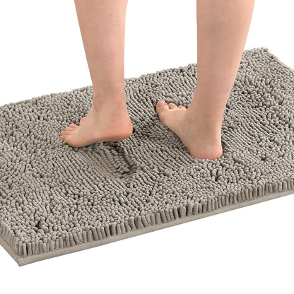 Feet on a grey extra soft absorbent non-slip bath mat in a bathroom setting, showcasing comfort and plush texture.