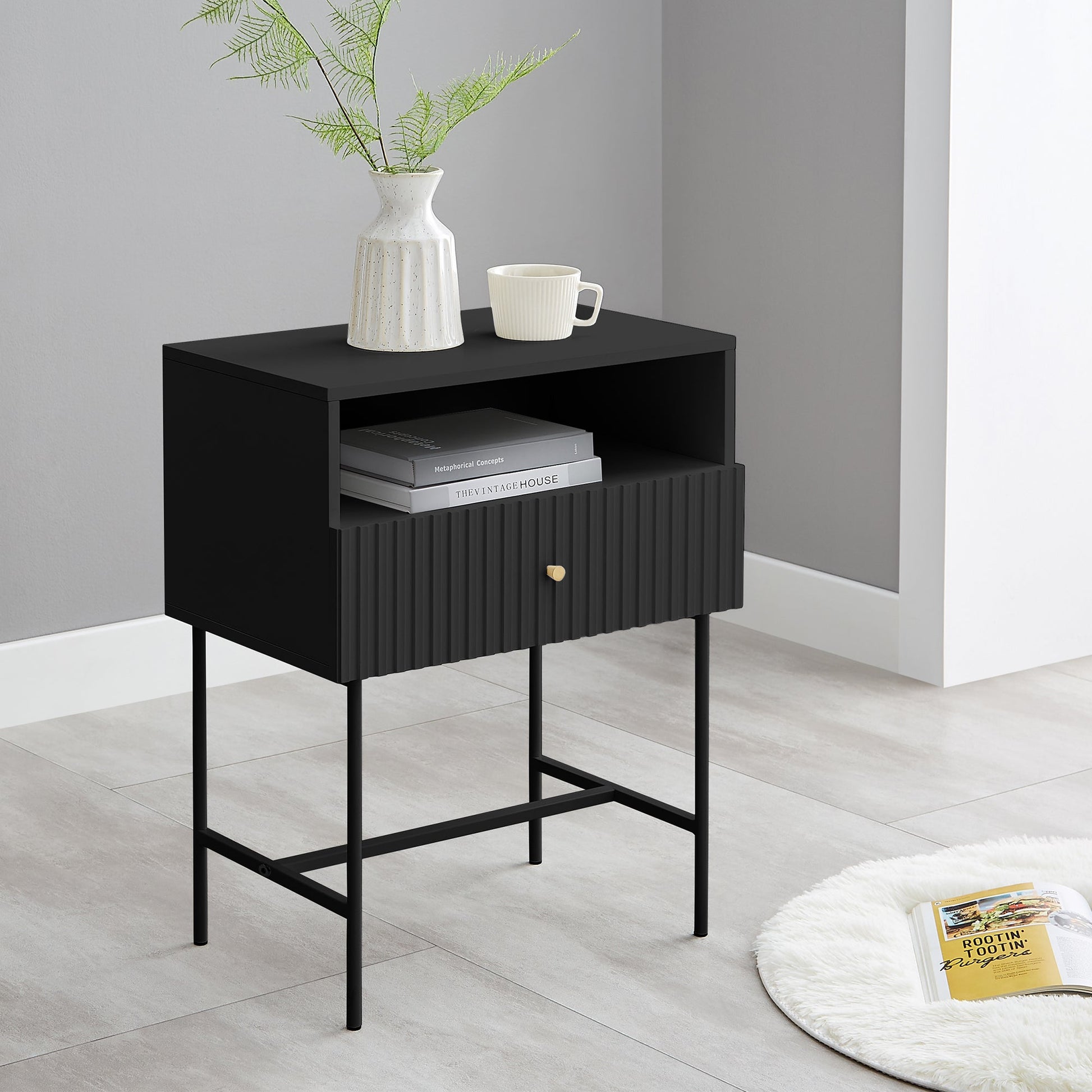 Black Lucia slender fluted bedside table with drawer and open shelf, featuring metal legs and melamine finish.