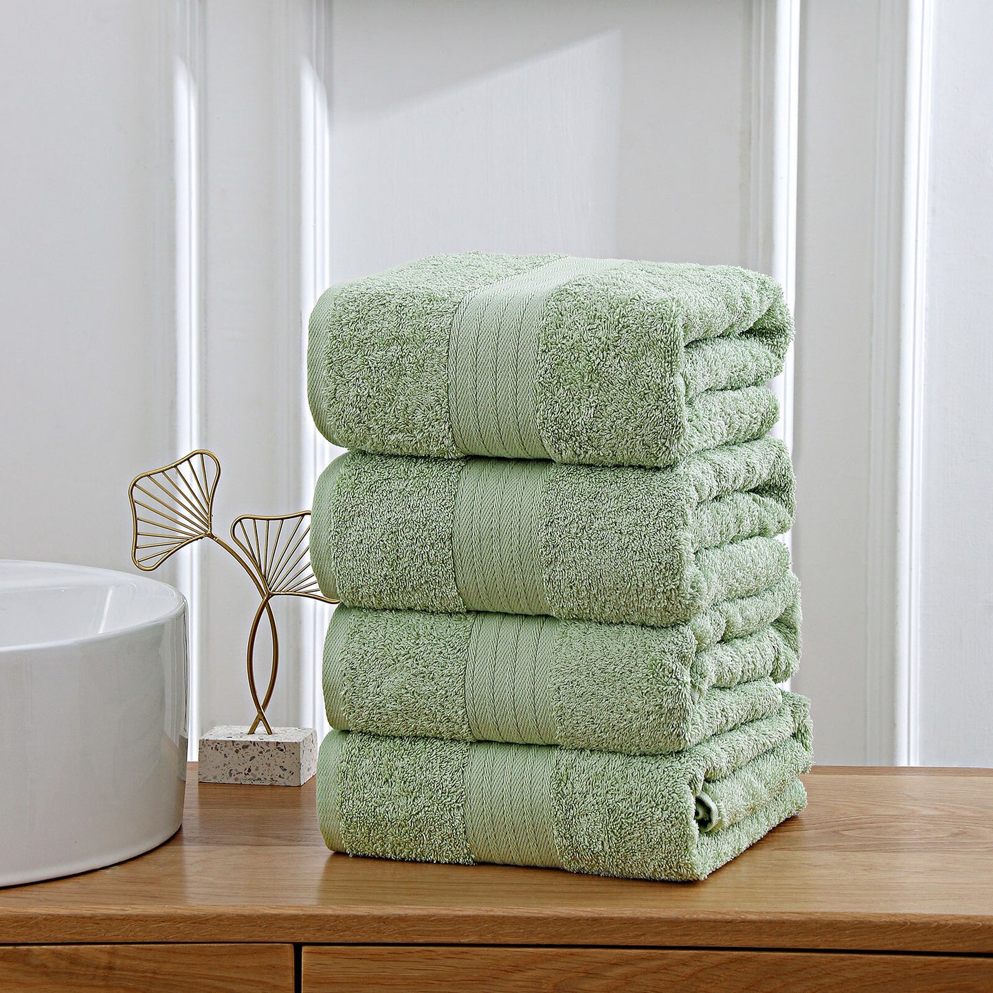 Sage green 4-piece cotton bath towel set, highly absorbent and fast-drying, perfect for the bathroom. OEKOTEX certified and safe for families.