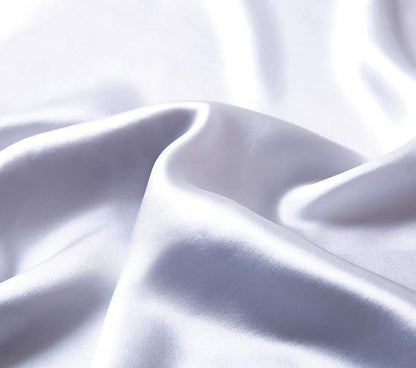 Luxurious pure mulberry silk fabric in silver, showcasing its smooth and glossy texture for ultimate comfort.