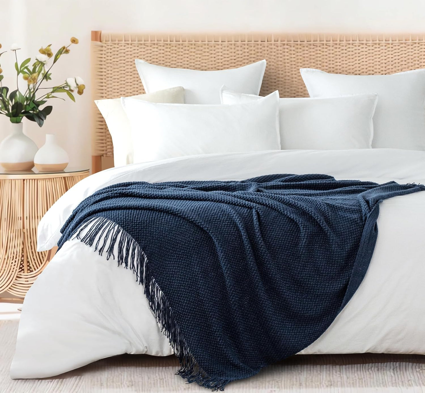 Navy micro plush knitted woven throw blanket on bed, adding elegance and warmth. Perfect for couch or sofa throws and blankets.