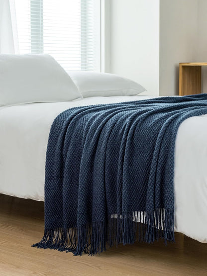 Navy micro plush knitted woven throw blanket on bed, cozy and elegant decor for couch or sofa, perfect for warmth and style.