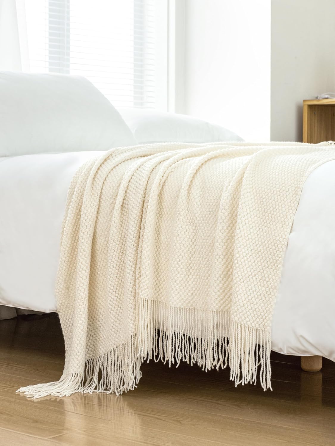 Cream Micro Plush Knitted Woven Throw Blanket on bed for warmth and elegance